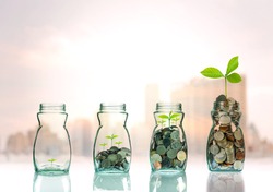 Mix coins and seed in clear bottle on cityscape photo blurred cityscape background,Business investment growth concept