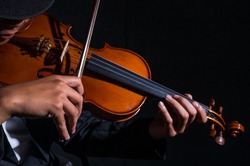 Close up Violin player in dark studio, Musical concept