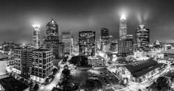 Black and white, aerial view of Charlotte, NC skyline on a foggy night. Charlotte is the largest city in the state of North Carolina and the 17th-largest city in the United States