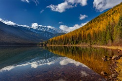 Great Northern Mountain reflects into Stanton Lake in autumn in the Flathead National Forest, Montana, USA