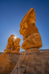 USA, Utah, Devil's Garden Outstanding Natural Area. Sun starburst on hoodoo rock formations.