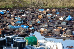 Site with chemically contaminated waste. Barrels with toxic waste in water.  Earth pollution problem