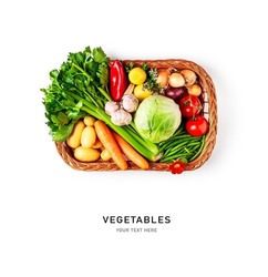 Vegetables in basket isolated on white background. Cabbage, celery, potato, pepper, onion, carrot, garlic, lemon, tomato and herbs creative arrangement. Healthy eating concept. Flat lay, top view