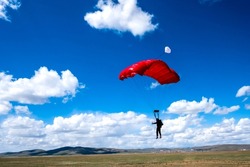 Skydiving parachutist about to land