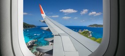 View from airplane. Flight window. Vacation destinations. Tropical beach.  Travel concept.