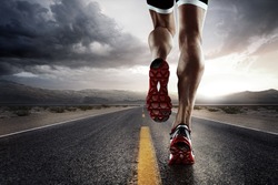 Sports background. Runner feet running on road closeup on shoe. 