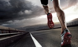 Sport. Runner feet running on road closeup on shoe.
