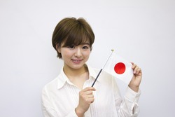 Young woman holding Japanese flag