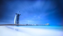 Burj Al Arab hotel on Jumeirah beach in Dubai, modern architecture, luxury beach resort, summer vacation and tourism concept