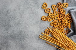 Mini pretzels and salted sticks. Crusty salted snack on a kitchen table. Top view.