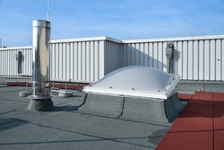 Flat roof vented skylight dome on an industrial building
