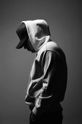 Young Man in Hat and Hood. Boy in a hooded sweatshirt Black and white portrait
