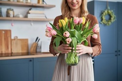 Caucasian woman holding bouquet of fresh tulips 