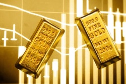 gold bar on the background of a laptop on which there is a trading price chart. Trading gold on the stock exchange and Forex.