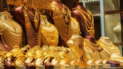 A showcase which is decorated with golden jewelleries in a shop   