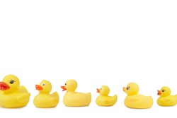 Line of cute rubber ducklings on white background. Clipping path included.