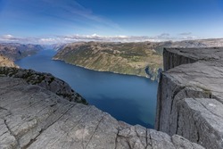 The famous and popular Preikestolen or Prekestolen (Pulpit Rock, Pulpit, Preacher's Chair), Strand, Rogaland, Norway. A steep cliff with a flat top which rises 604 metres above Lysefjorden.