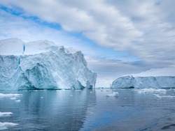 Awe-inspiring icy landscapes at the mouth of the Icefjord glacier (Sermeq Kujalleq), one of the fastest and most active glaciers in the world. Disko Bay, Ilulissat, Greenland