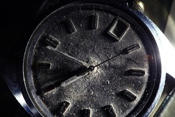 Time concept. Extreme closeup of very old wristwatch with dust