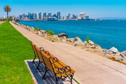 A sidewalk lines the waterfront of San Diego and beckons you to sit on a bench and look at the skyline and Coronado Bay Bridge.