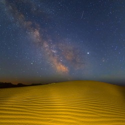night scene, sandy desert after a rain under the starry sky with milky way