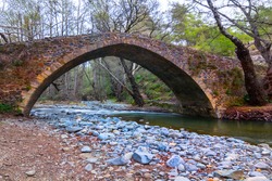 old medieval stony bridge over the small river
