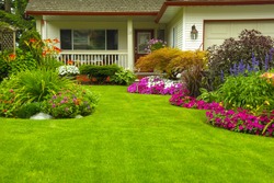 Manicured House and Garden displaying annual and perennial gardens in full bloom.