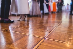 Couples dance on the historical costumed ball in historical dresses, classical ballroom dancers dancing, waltz, quadrille and polonaise in palace interiors on a wooden floor, charity event
