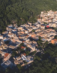 Beautiful aerial drone view of Lakones Village, traditional greek village near Paleokastritsa, Corfu island, Kerkyra, Ionian sea islands, Greece, in summer sunny day with a blue sky and mountains
