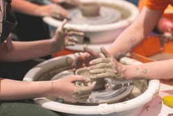 Pottery lesson master class for kids children, process of making clay pot on pottery wheel, potter wet hands creating ceramic crockery handcrafts, ceramist molding jar or vase