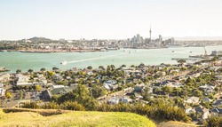 Breathtaking view of Auckland city skyline and bay gulf from Mount Victoria in Devonport area - High angle sight of the New Zealand world famous town - Bright greenish vintage filter