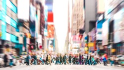 Defocused background of people walking on zebra crossing on 7th avenue in Manhattan - Crowded streets of New York City during rush hour in urban area - Vivid sunset filter with soft sharp focus
