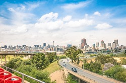Wide angle view of Johannesburg skyline from the highways during a sightseeing tour around the urban area - Metropolitan buildings of the business district in the capital of South Africa