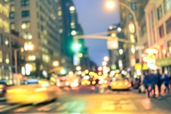 New york City abstract rush hour - Defocused yellow taxi cabs and traffic jam on 5th avenue in Manhattan downtown at blue hour - Blurred bokeh postcard on a retro vintage nostalgic filtered look