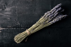 bunch of lavender tied with twine on a dark background - top view with copyspace