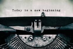 Today is a new beginning words typed on a vintage typewriter in black and white. 
