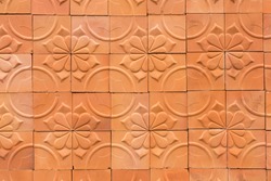 The walls decorated with terracotta tiles
