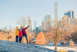 Family of father and kids in Central Park on winter vacation in NYC