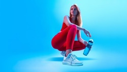 Fitness neon light sporty concept portrait of fitness female model in abstract style background. Health care concept. Healthy lifestyle. Fitness woman taking break after at gym