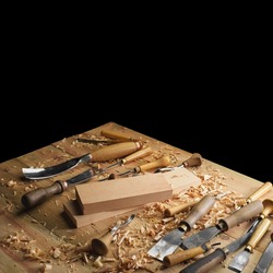 Woodworker's desk. Woodworking cutters and shavings on a wooden table. Wood carving process concept with free space on top