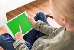 Digital tablet with empty black screen. Young girl holding tablet pc in her hands with blank green screen. Concept for video-sharing platform