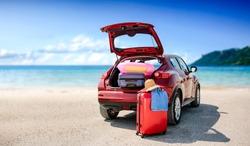 Summer time and red car on beach with few suitcase. Free space for your text or product. 