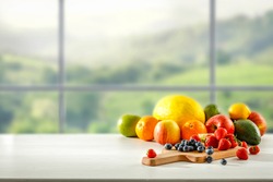 Fresh fruit in the kitchen on a wooden table by the sunny window