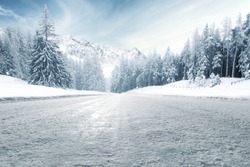 winter road and trees with snow and alps landscape 