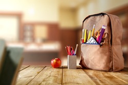 old wooden school table and school supplies on September day