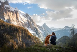 girl with a toller dog in the mountains. Autumn mood. Traveling with a pet. Nova Scotia Duck Tolling Retriever