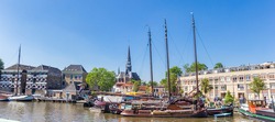 Panorama of old wooden sailing ships in the harbor of Gouda, Netherlands
