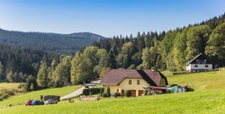 Panorama of a house in the landscape of the Sumava mountains national park, Czech Republic