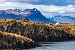 Typical Icelandic landscape with houses against mountains in small village of Stykkisholmur, Western Iceland