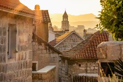 Sunrise over the Split old town. Narrow medieval paved street in old town of Split at sunrise, Croatia